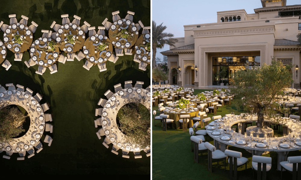 Elegant outdoor wedding setup featuring a round table surrounded by lush greenery, creating a whimsical and romantic atmosphere for guests.