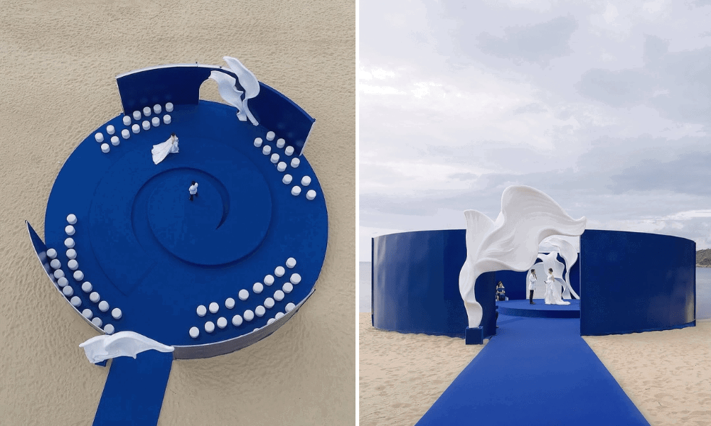 A wedding aisle featuring bold hues of blue in contrast to white seating arrangements